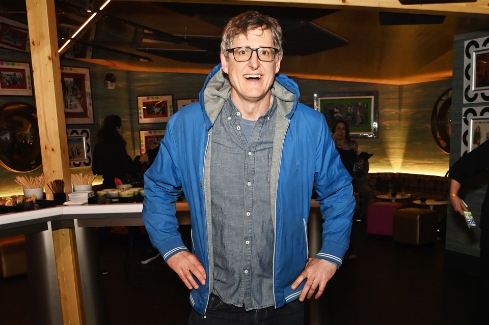 Louis Theroux smiling at an event.