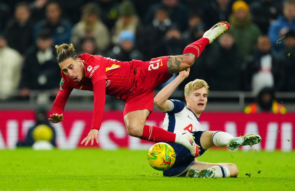 Lucas Bergvall of Tottenham Hotspur tackles Kostas Tsimikas of Liverpool during a football match.