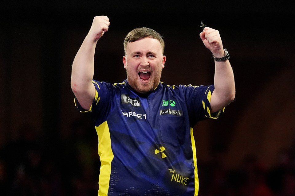 Luke Littler celebrates winning a darts championship.