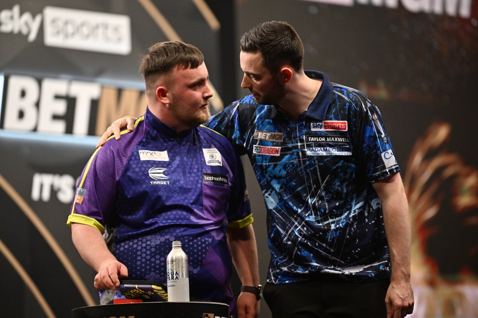 Luke Littler congratulated by Luke Humphries after a darts match.