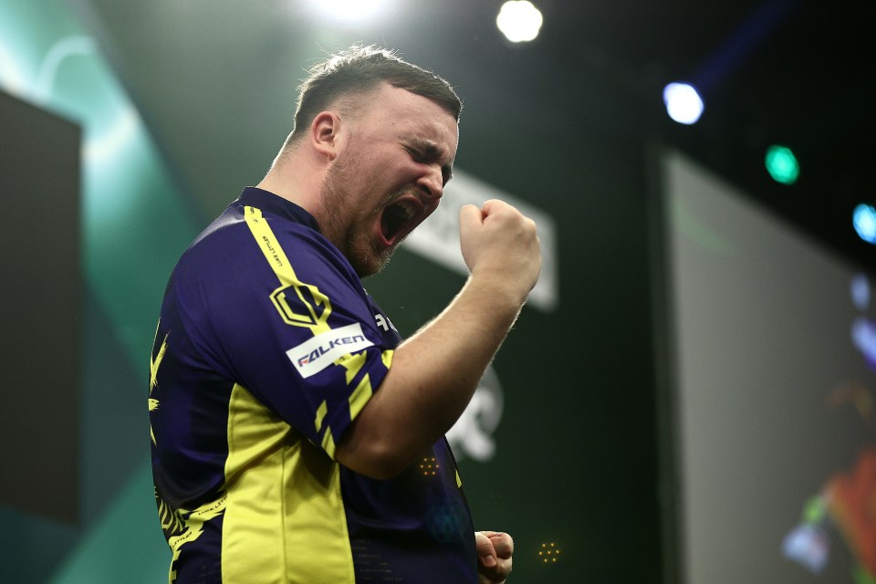 Luke Littler celebrates a darts victory.