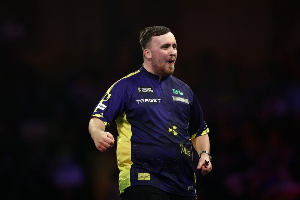 Luke Littler of England reacts during a darts match.