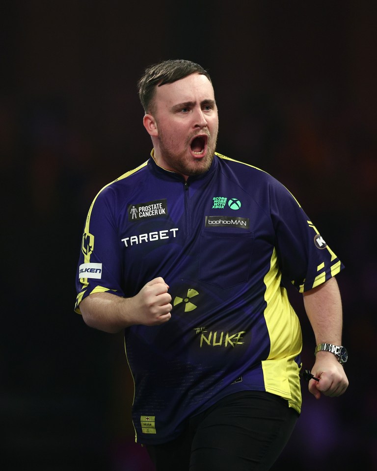 Luke Littler celebrating during a darts match.