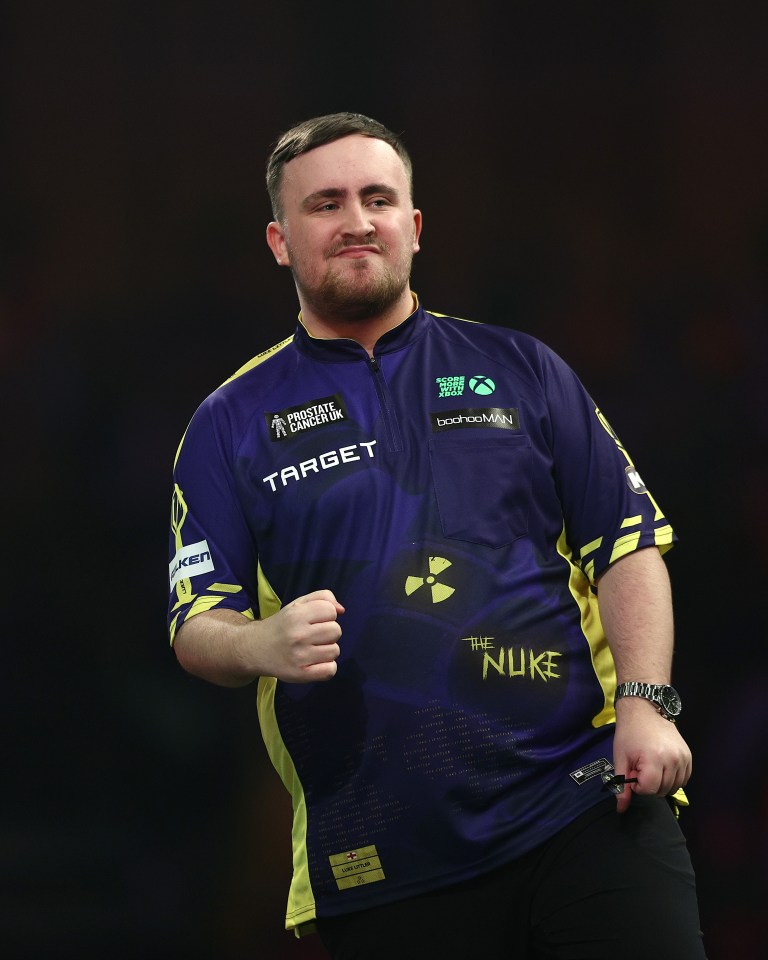 Luke Littler of England reacts during a darts match.