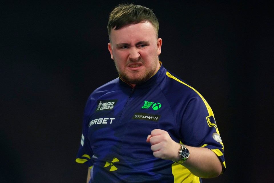 Luke Littler of England celebrates during a World Darts Championship semifinal match.