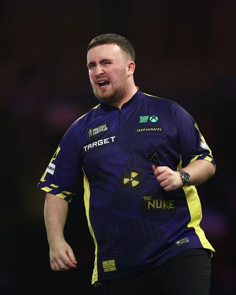 Luke Littler of England during a darts match.