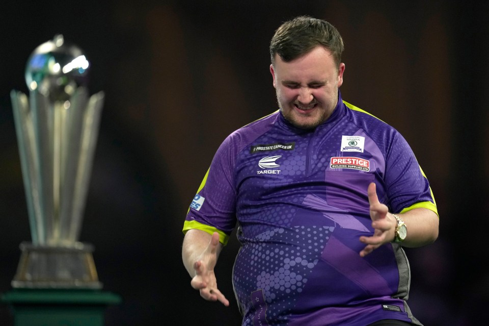 Luke Littler grimacing during a darts match.