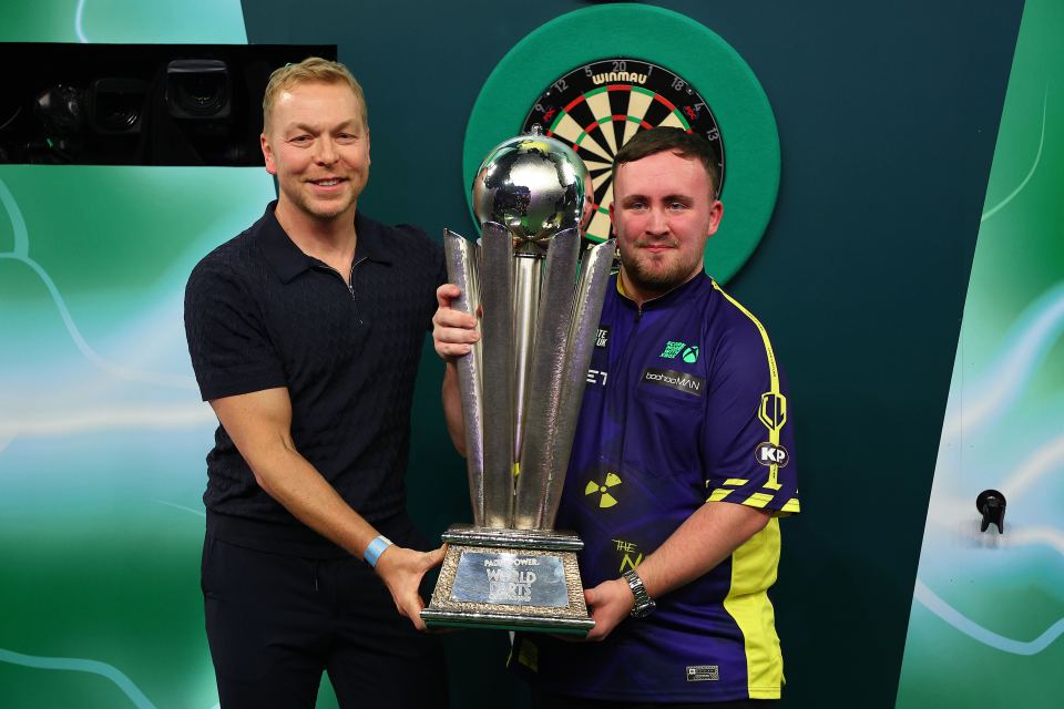 Luke Littler and Sir Chris Hoy with the PDC World Darts Championship trophy.