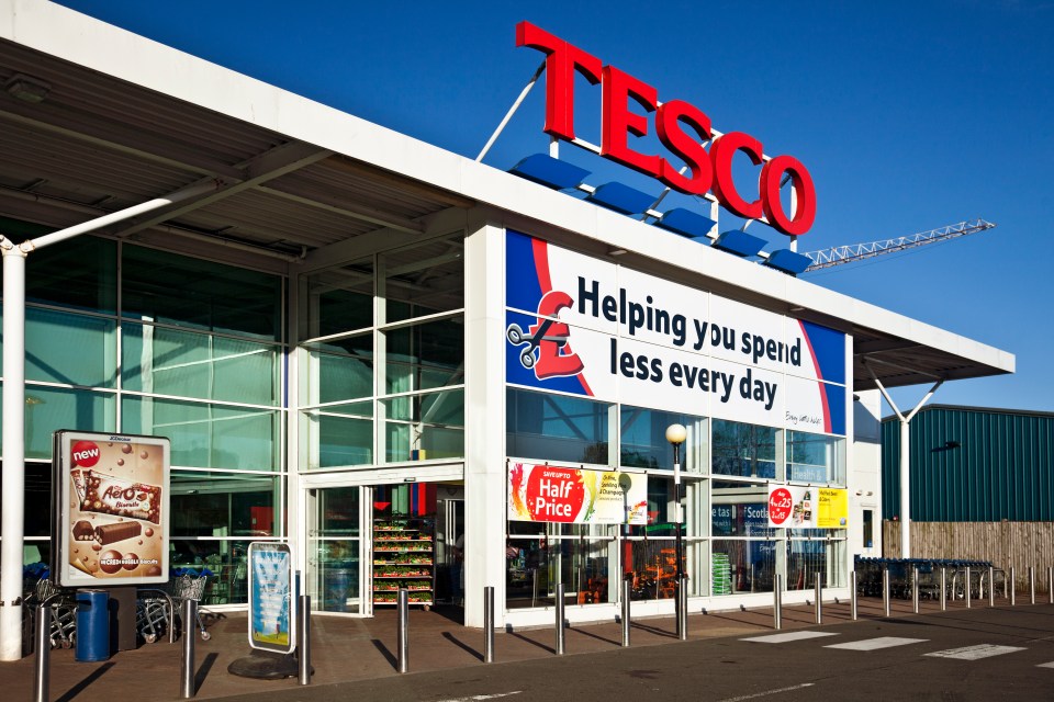 Tesco superstore entrance with signage advertising sales and Aero biscuits.