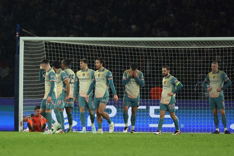 Manchester City players by the goal after conceding a goal.