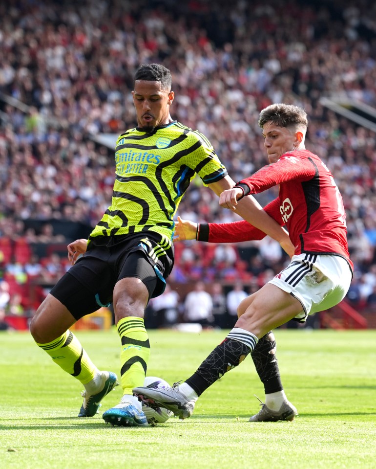 Arsenal's William Saliba and Manchester United's Alejandro Garnacho battling for the ball.