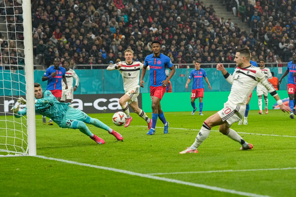 Diogo Dalot scoring a goal during a soccer match.