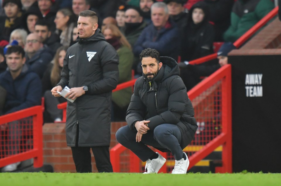 Ruben Amorim, Manchester United's manager, crouching on the sidelines.