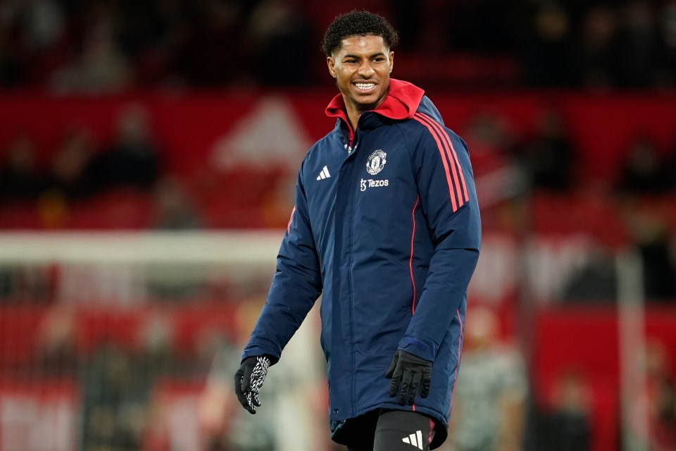 Marcus Rashford smiling during a Manchester United warm-up.