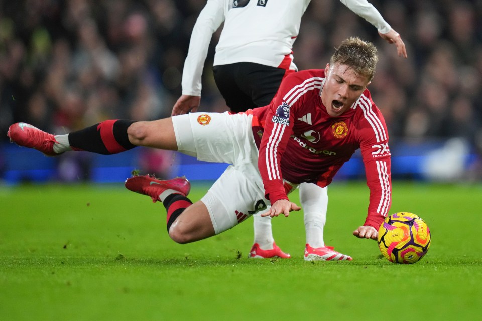 Rasmus Hojlund of Manchester United falls to the ground during a soccer match.