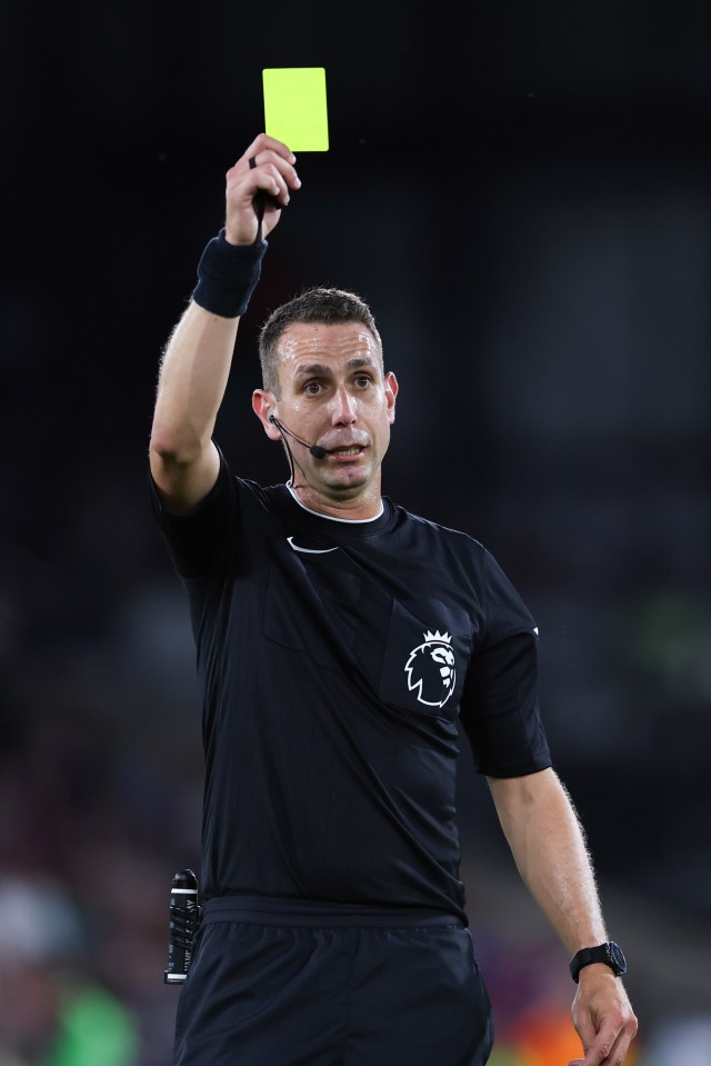 Soccer referee showing a yellow card.