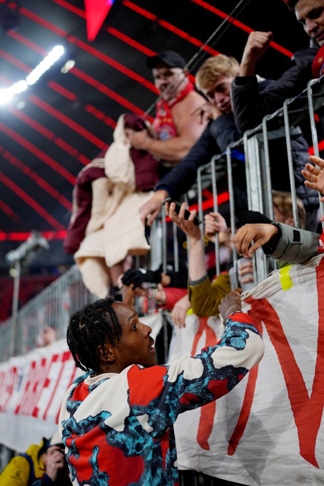 Mathys Tel of Bayern Munich interacting with fans after a game.