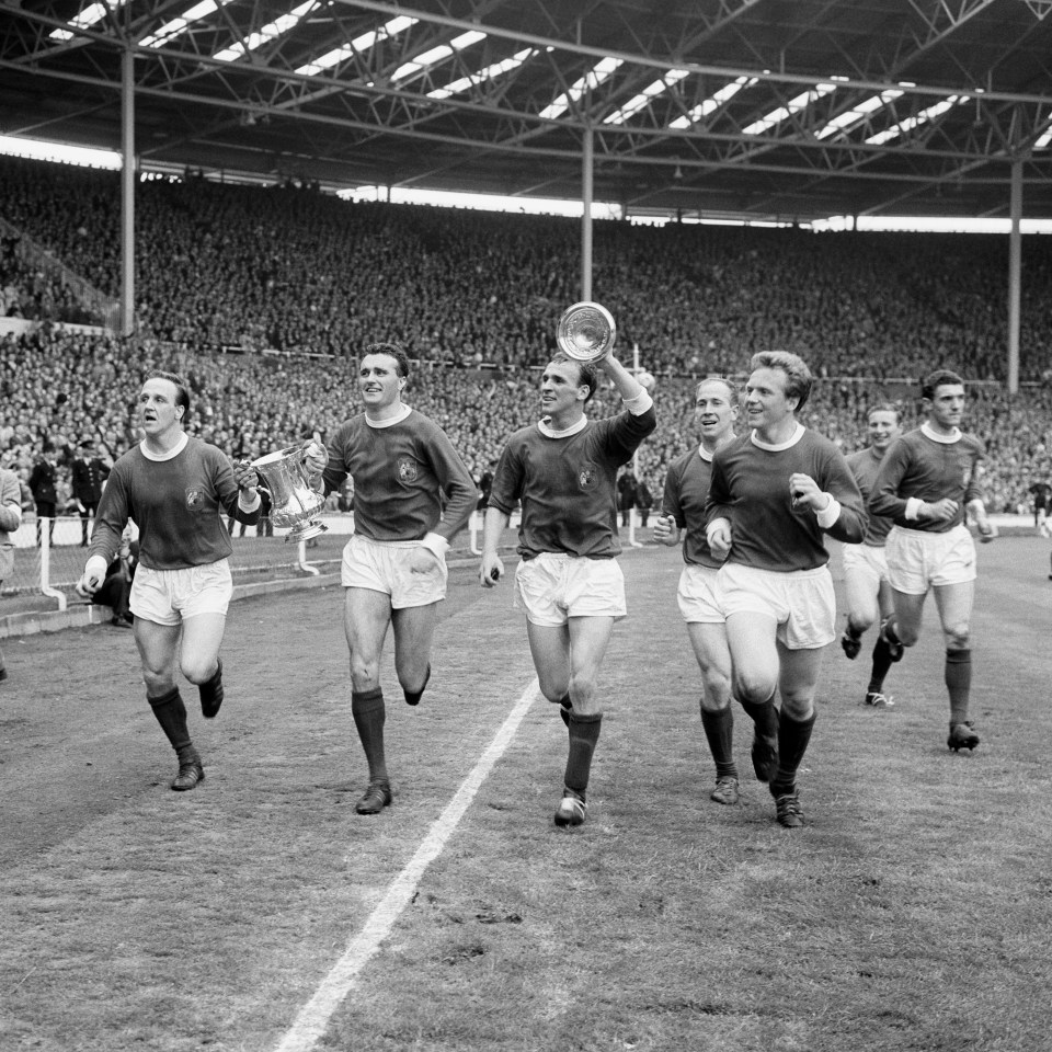 Manchester United players celebrating an FA Cup victory.