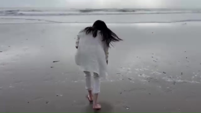 Meghan Markle walking on a beach.