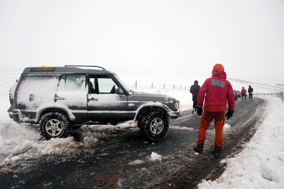 A member of a Mountain Rescue team after helping to clear cars from a snow drift near Ribblehead, in North Yorkshire