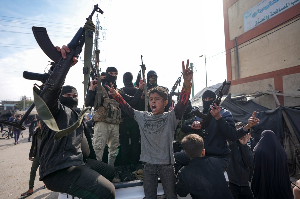 Members of the Izzedine al-Qassam Brigades celebrating a ceasefire, holding weapons.