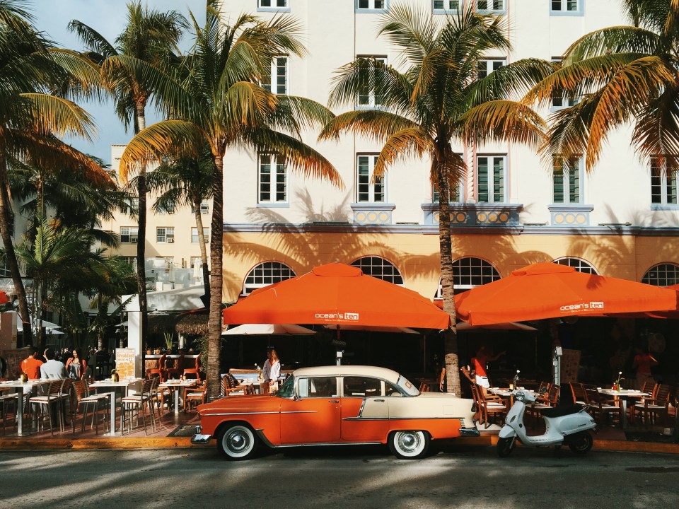 Classic car parked outside a Miami Beach restaurant.