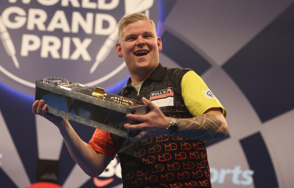 Mike De Decker of Belgium celebrates winning the World Grand Prix darts trophy.