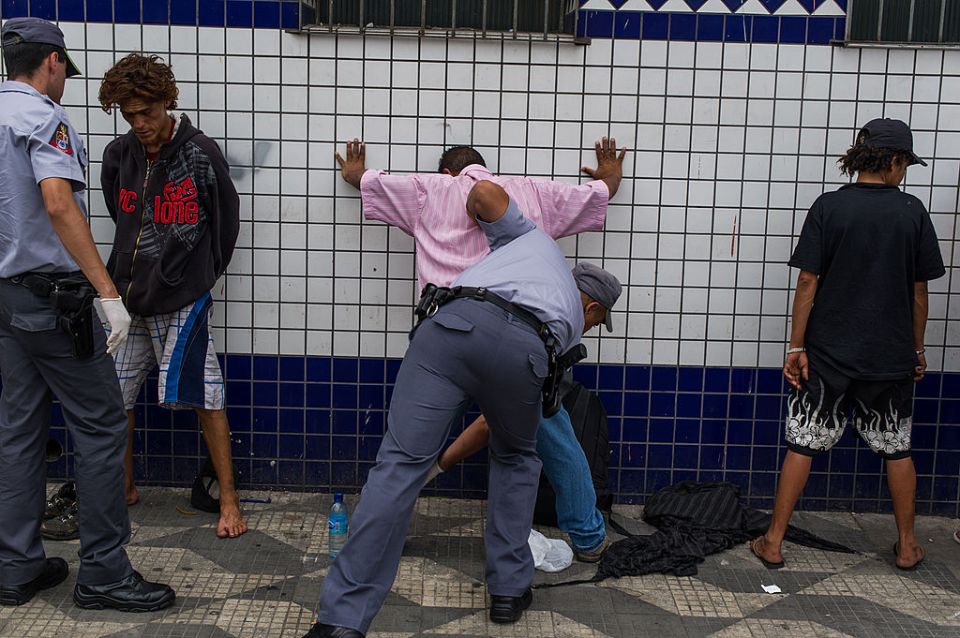 Military policemen frisk drug addicts in Sao Paulo, Brazil.