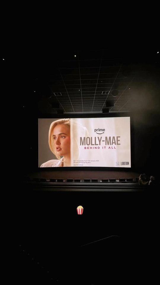 Molly-Mae Hague's "Behind It All" Amazon Prime show preview on a movie screen.