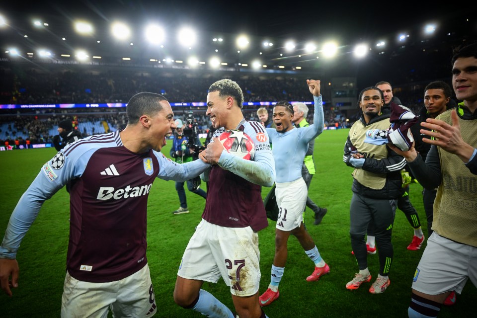 Aston Villa players celebrating a victory with the match ball.