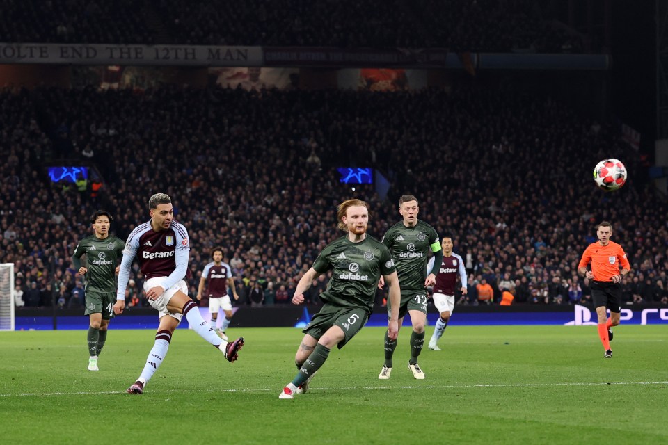 Aston Villa player scoring a goal during a soccer match.