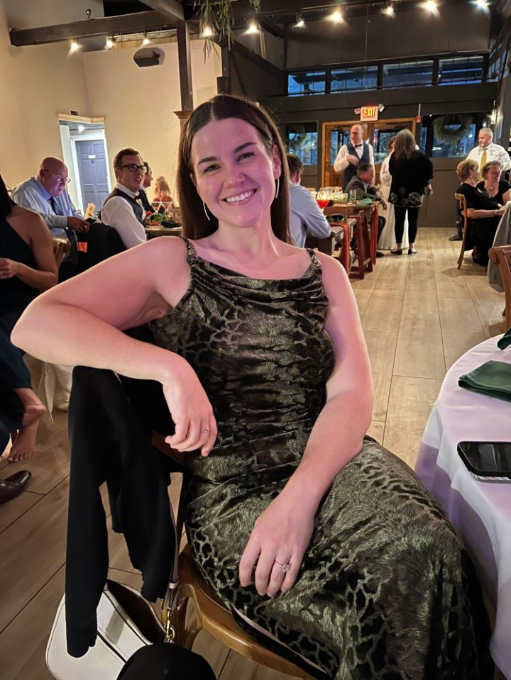 Woman in green dress at a wedding reception.