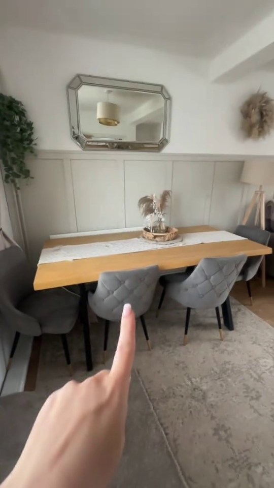 Dining room with light wood table and gray chairs.