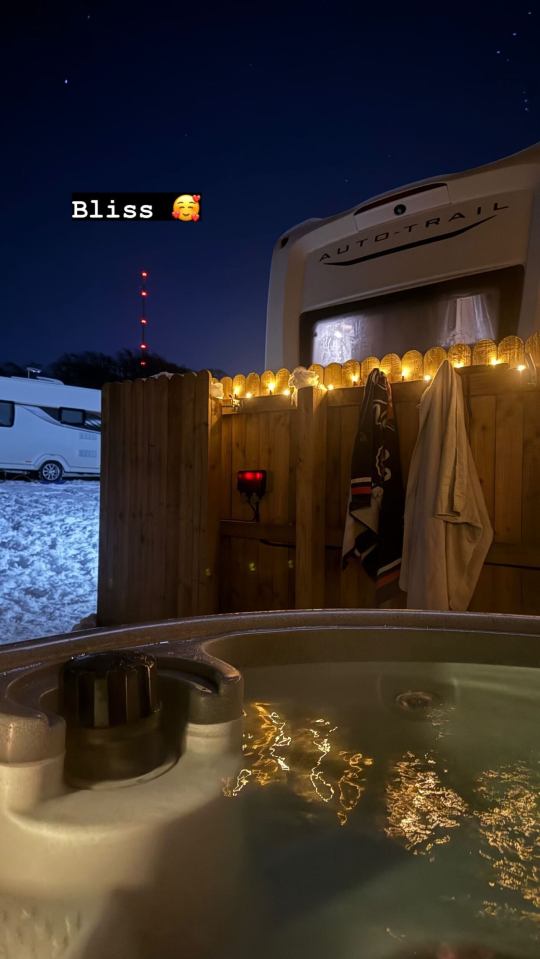 Hot tub at night next to a motorhome.