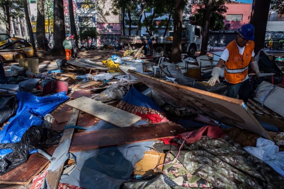 Municipal workers clearing debris from demolished shacks in Sao Paulo.