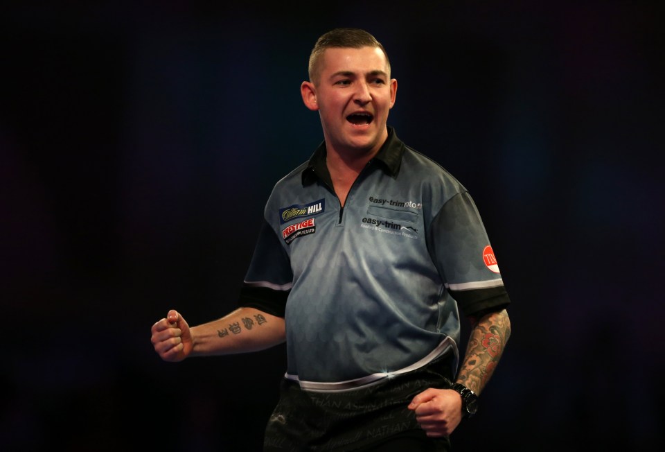 Nathan Aspinall celebrates a win at the World Darts Championship.