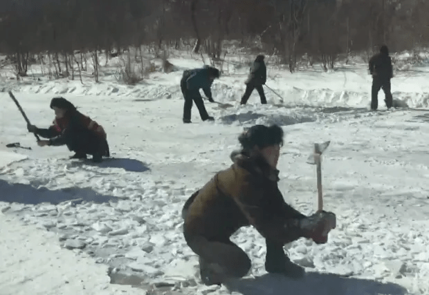 Young people forced to plough snow with their hands