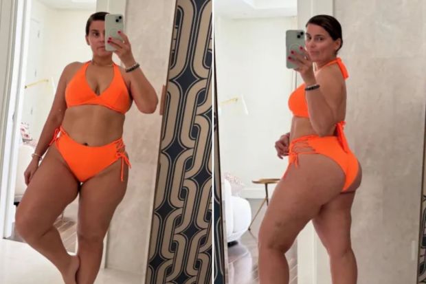 Woman in orange bikini taking a selfie.