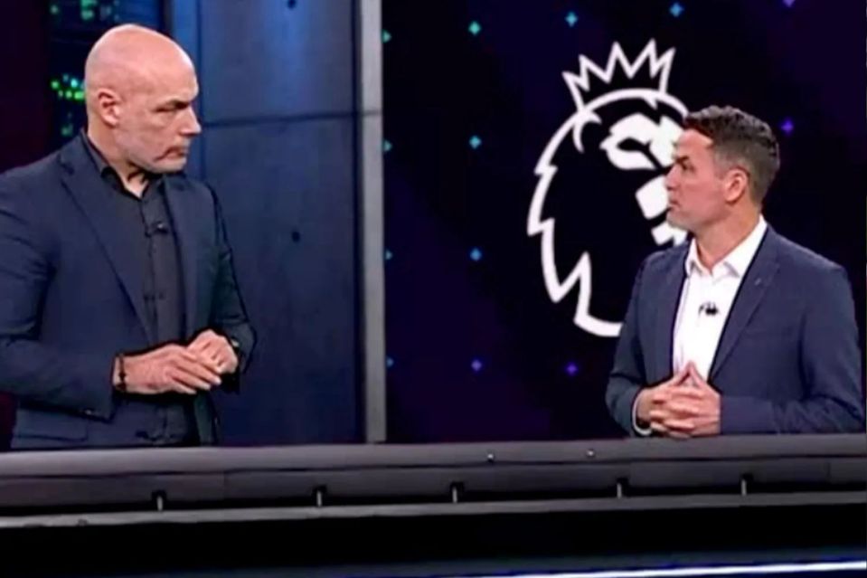 Two men sitting at a desk in front of a Premier League logo.