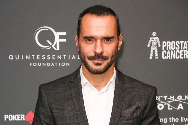 Headshot of a man in a suit at an event.