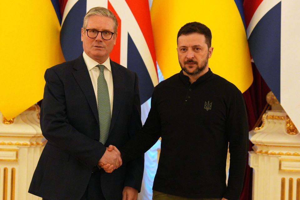 Keir Starmer and Volodymyr Zelenskyy shaking hands.