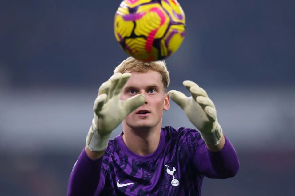 Soccer goalie catching a ball.