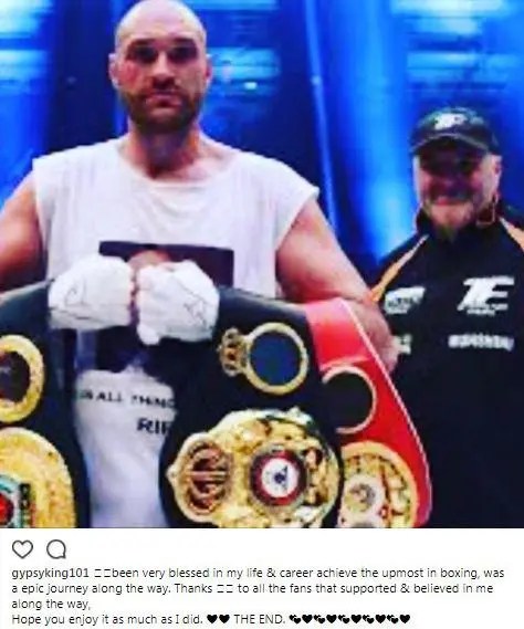 Boxer Tyson Fury holding championship belts.