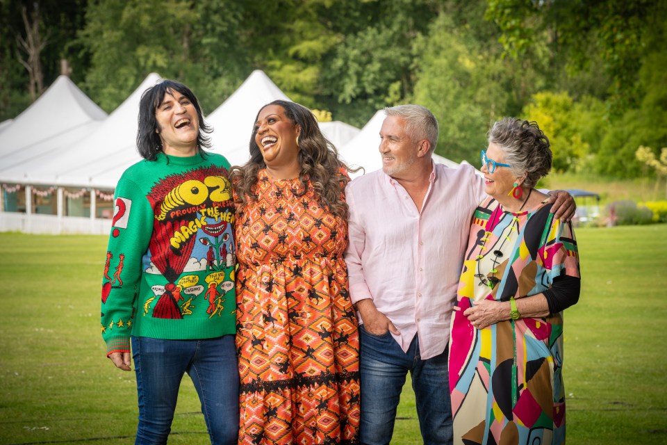 The Great British Bake Off judges and presenters: Noel Fielding, Prue Leith, Alison Hammond, and Paul Hollywood, playing tic-tac-toe with cream puffs and holding donuts.