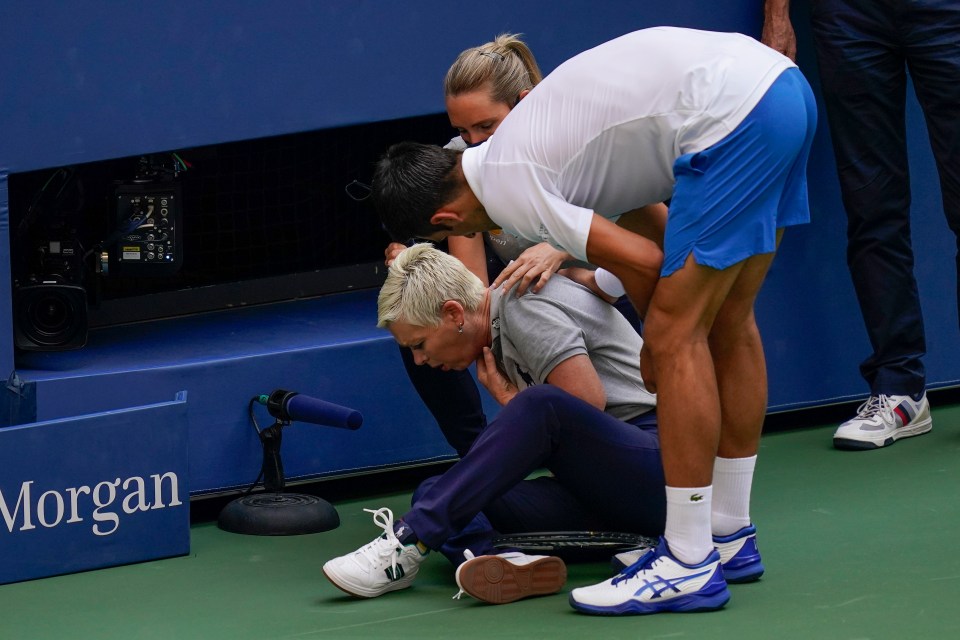 Novak Djokovic attending to a lineswoman injured by a tennis ball.