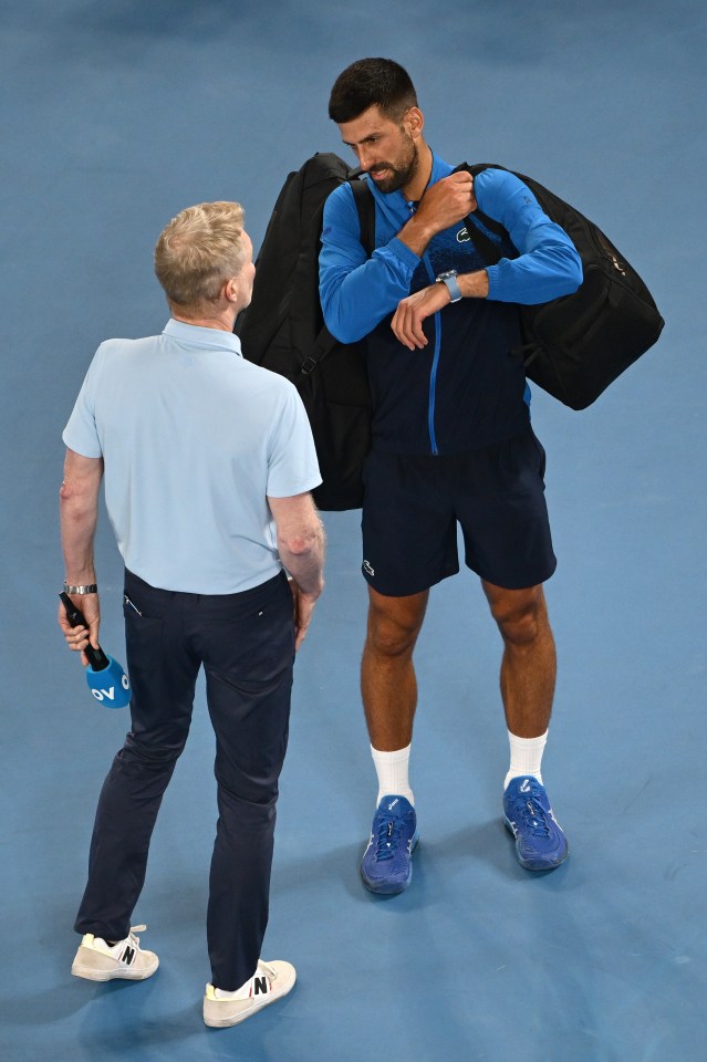 Novak Djokovic speaks with an interviewer after a tennis match.