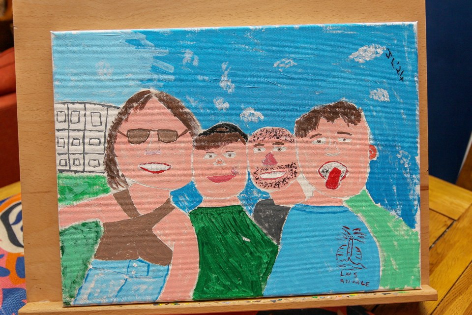 Illustration of a family portrait painted in a childlike style.