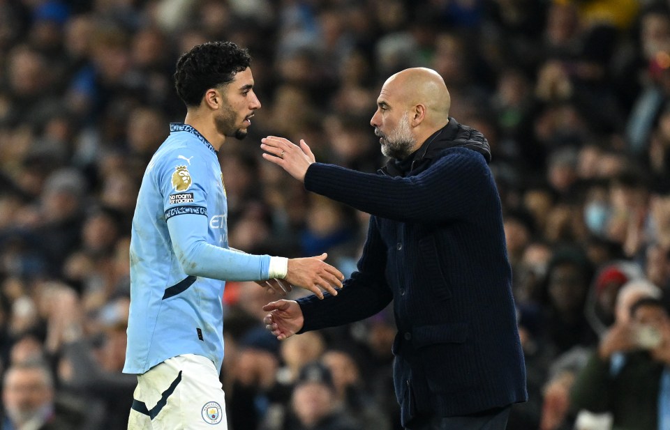 Omar Marmoush of Manchester City embraced by Pep Guardiola after being substituted.