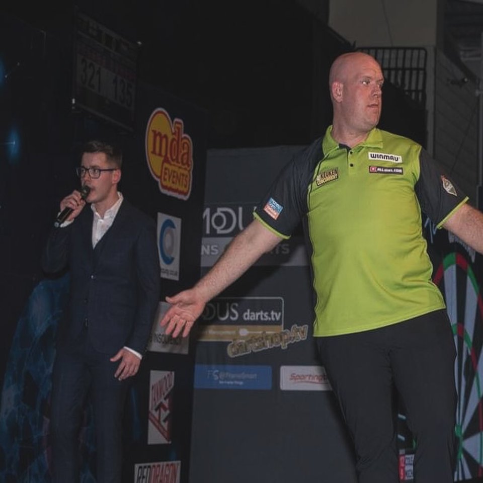 Owen Binks, darts referee, on stage with a commentator.