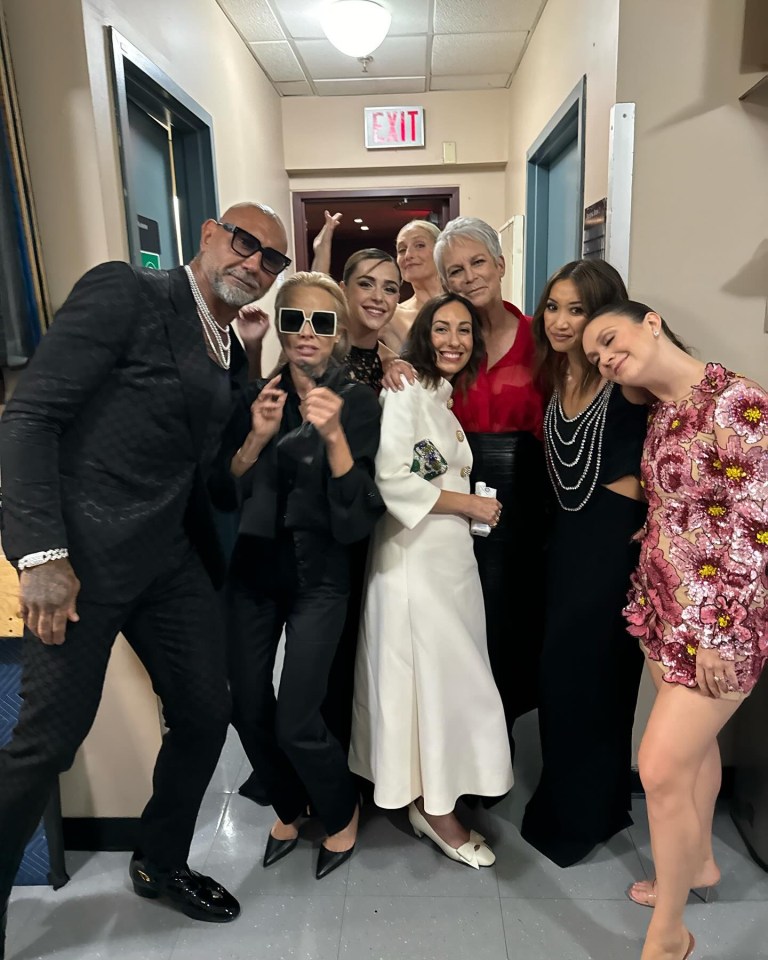 Group photo of Pamela Anderson and other showgirls backstage.